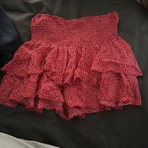 Cute red skirt with white flowers. In xs